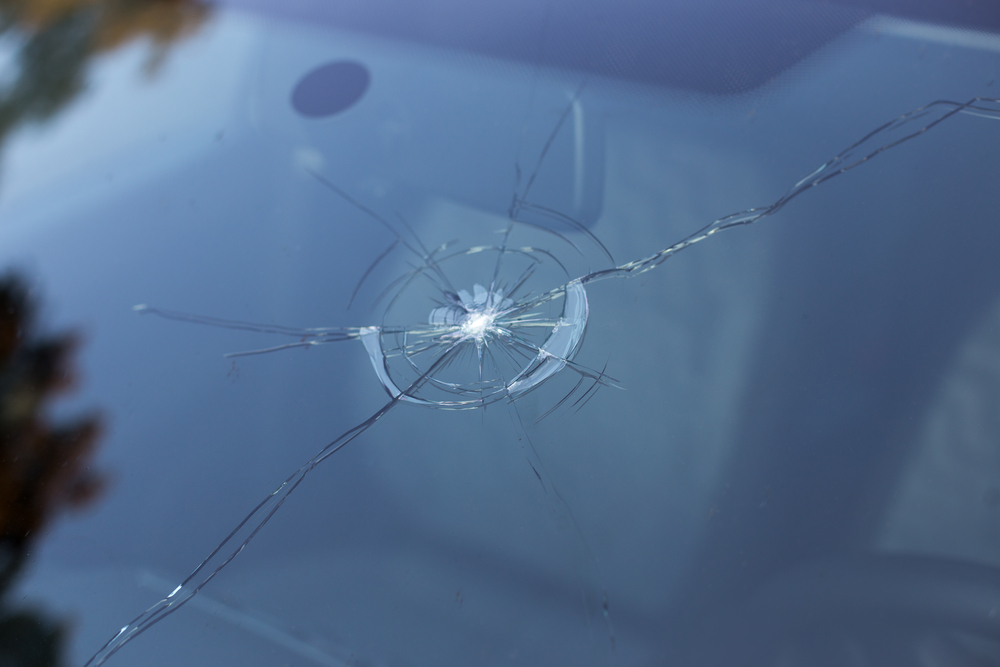 How does a windscreen get damaged when driving?